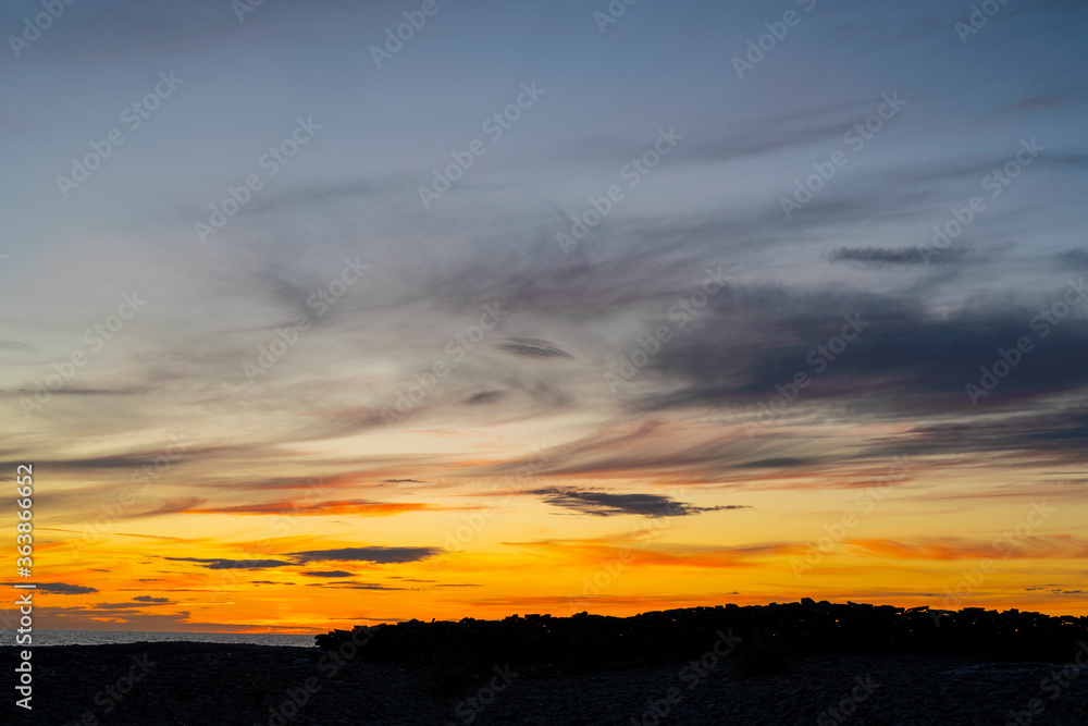 Obraz premium Coastal landscape during an summer sunset at Blasé on the island of Gotland in Sweden