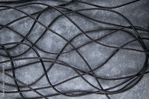 a lot of black wires from different electrical appliances are on the floor