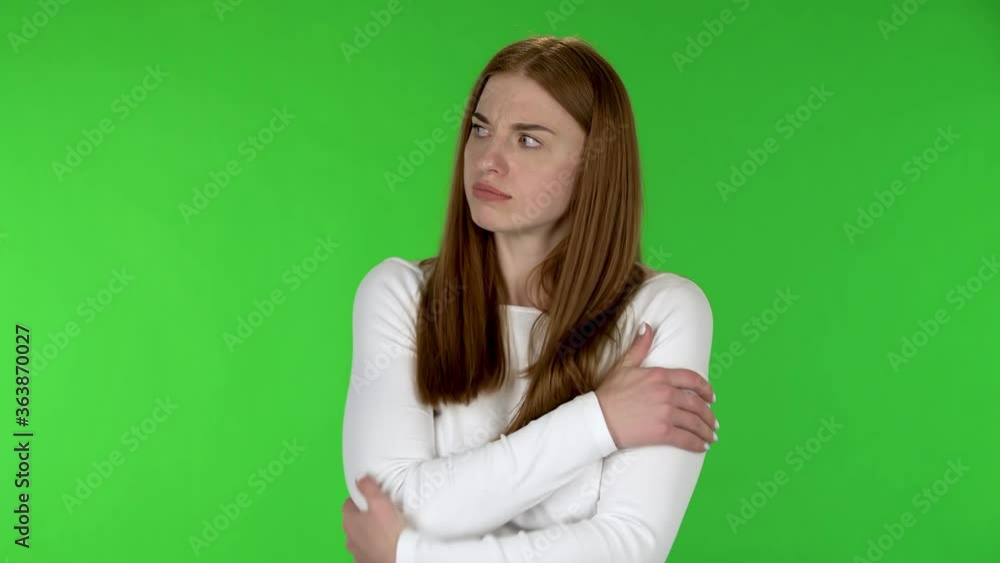 Portrait of pretty young woman is frozen and trying to keep warm. Portrait of pretty young woman is frozen and trying to keep warm.