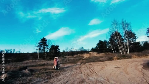 Aerial view of woman and little girl walking cute dog outdoors photo