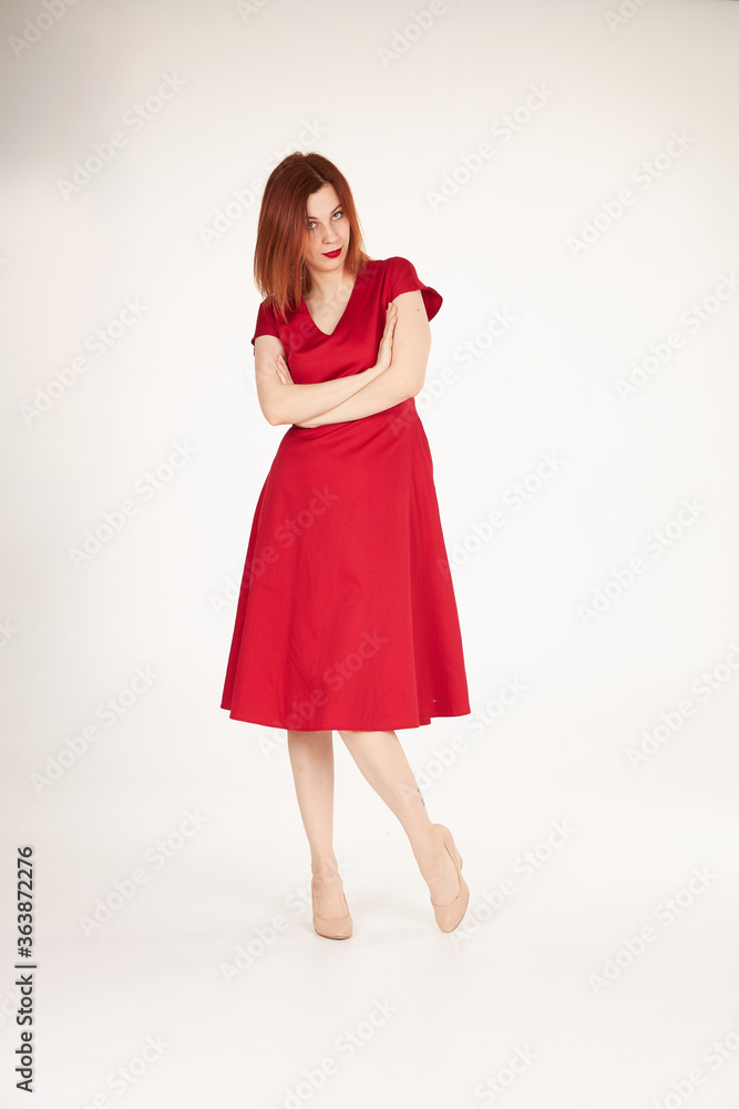 Smiling redhead girl on white background red dress Smiling redhead girl on white background red dress