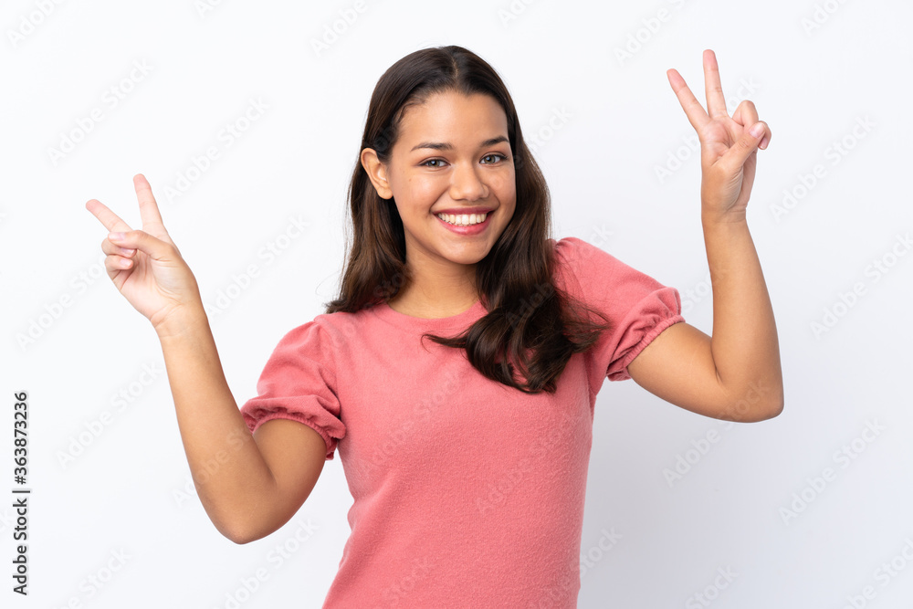 Young Colombian girl over isolated white background showing victory sign with both hands Young Colombian girl over isolated white background showing victory sign with both hands