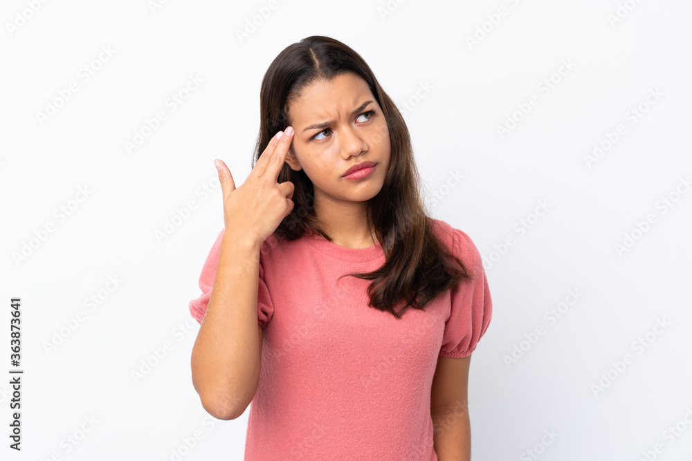 Young Colombian girl over isolated white background with problems making suicide gesture Young Colombian girl over isolated white background with problems making suicide gesture