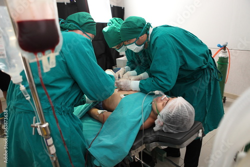 Team of professional surgeons performing operation in hospital operation theater