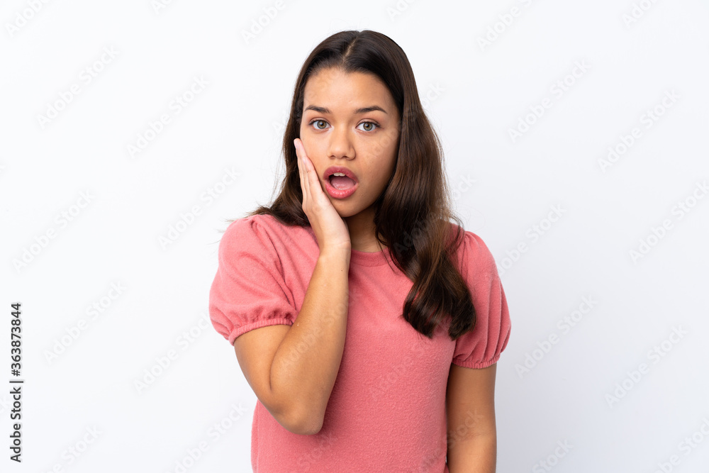 Young Colombian girl over isolated white background surprised and shocked while looking right Young Colombian girl over isolated white background surprised and shocked while looking right