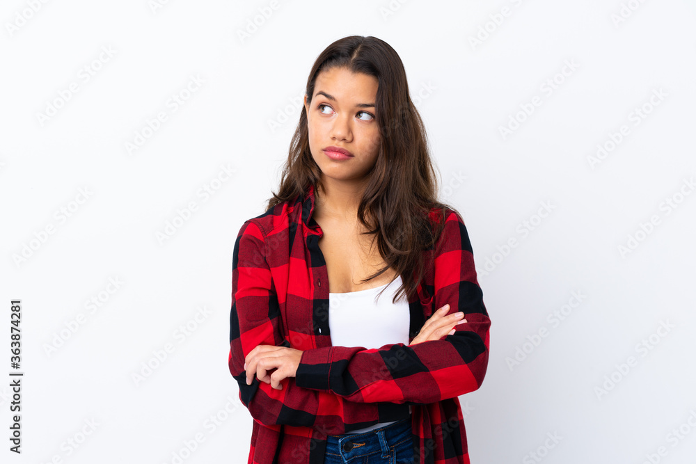 Young Colombian girl over isolated white background thinking an idea Young Colombian girl over isolated white background thinking an idea