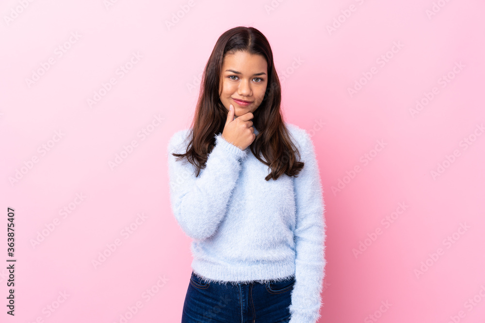 Young Colombian girl over isolated pink background laughing Young Colombian girl over isolated pink background laughing