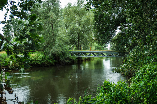 View of the bridge over river Dommel. Colorful landscape park with beautiful trees and water in provinces Noord Brabant  the Netherlands.