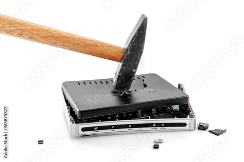 Hammer smashing Internet modem router to pieces. On a white background close-up. A day without internet.