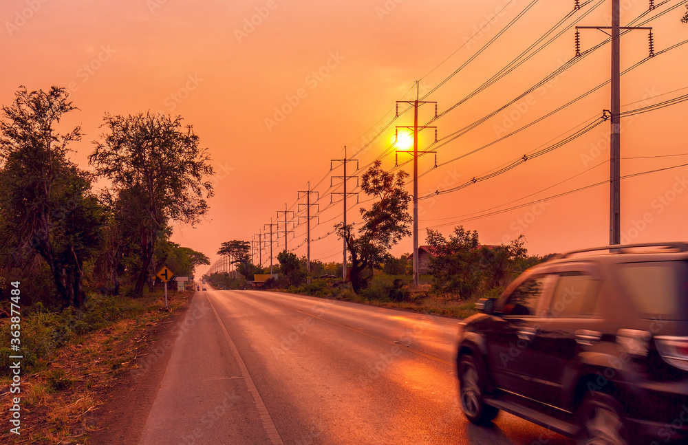 Electric pole with cable on dramatic sunset sky along the road Electric pole with cable on dramatic sunset sky along the road