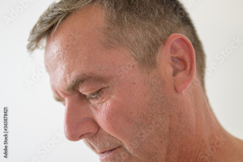 Close up cropped side profile of a middle-aged man