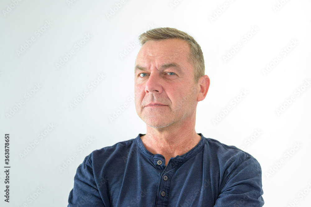 Thoughtful man glancing sideways at camera Thoughtful man glancing sideways at camera