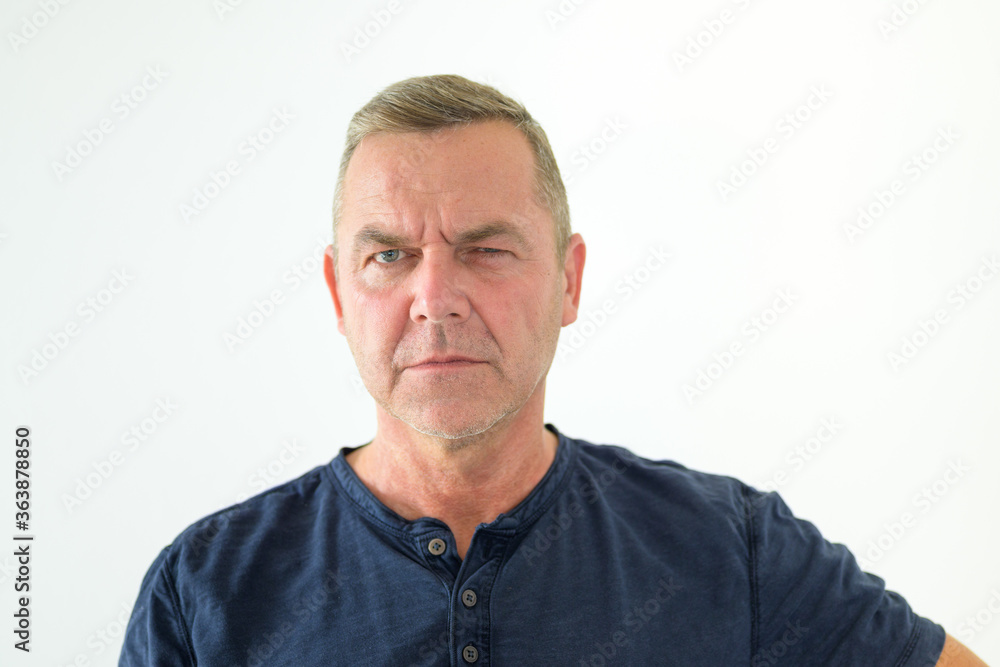 Thoughtful man glancing sideways at camera Thoughtful man glancing sideways at camera