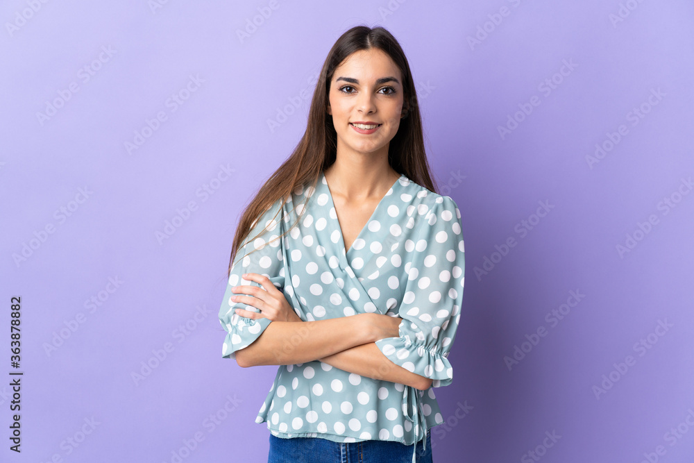 Young caucasian woman isolated on blue background keeping the arms crossed in frontal position Young caucasian woman isolated on blue background keeping the arms crossed in frontal position
