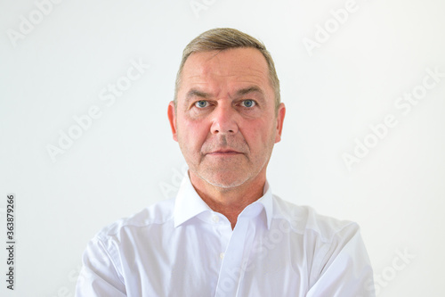 Fotografie Serious middle-aged man with deadpan expression