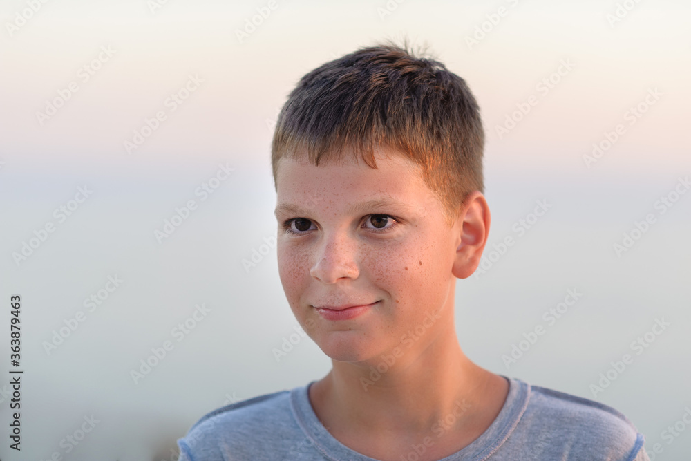 Portrait of a smiling boy, close-up, tan, evening shot. Portrait of a smiling boy, close-up, tan, evening shot.