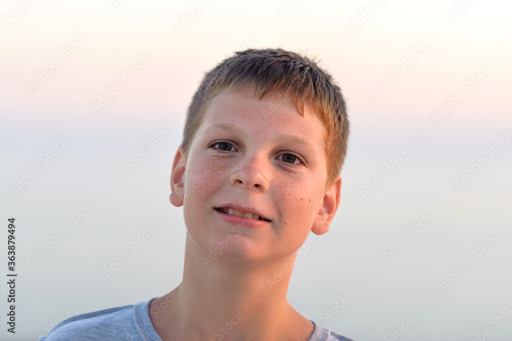 Portrait of a grimacing boy, close-up, tan, evening shot. Portrait of a grimacing boy, close-up, tan, evening shot.