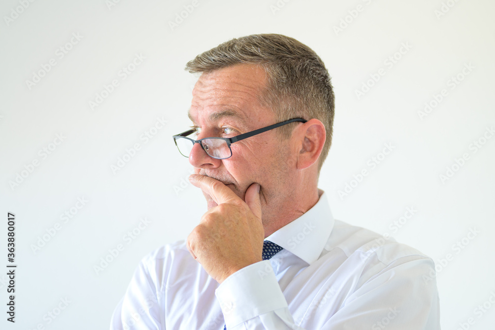 Thoughtful man wearing spectacles looking aside Thoughtful man wearing spectacles looking aside