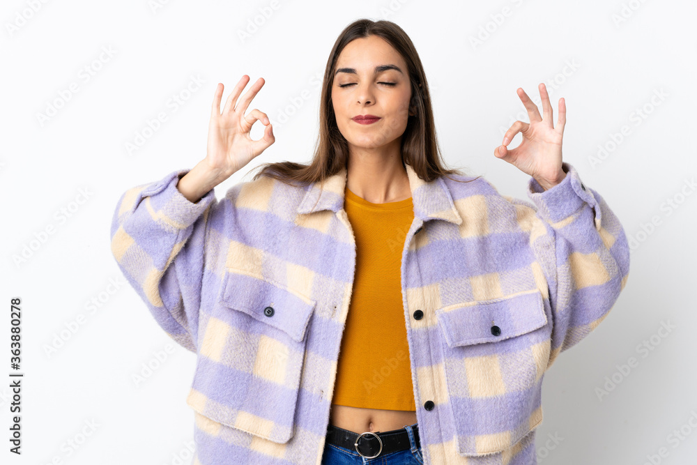 Young caucasian woman isolated on purple background in zen pose Young caucasian woman isolated on purple background in zen pose