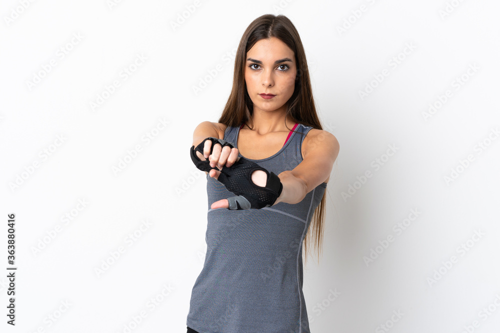 Fototapeta premium Young caucasian woman isolated on white background stretching arm