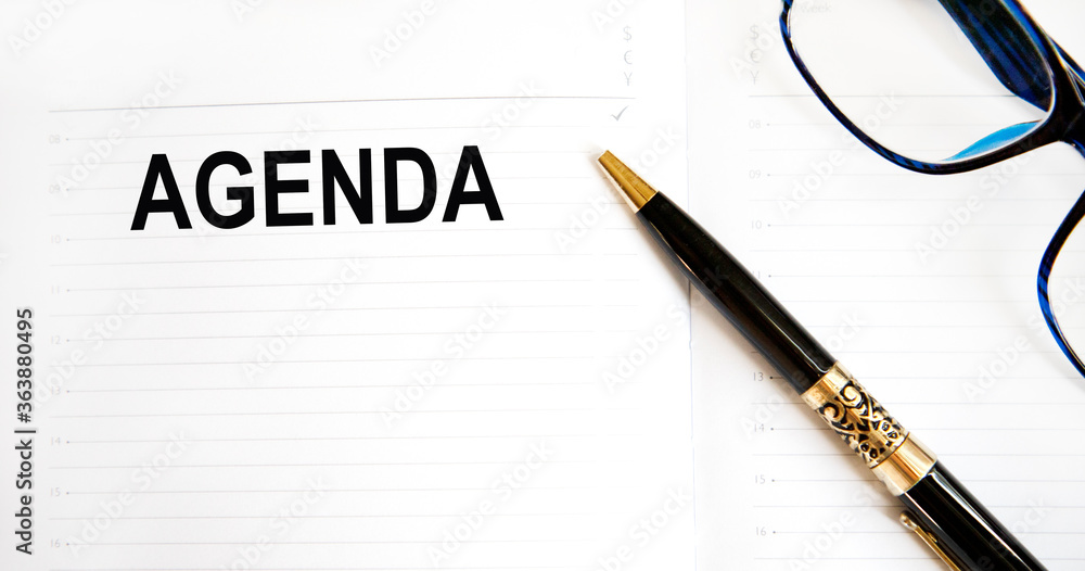Agenda written on notebook with blank list, planning conceptual Agenda written on notebook with blank list, planning conceptual