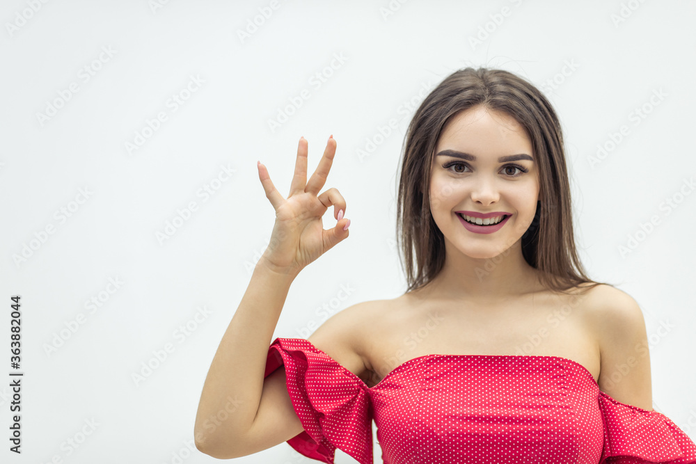 Close up image of lovely girl showing ok sign and smiling over white background. Close up image of lovely girl showing ok sign and smiling over white background.