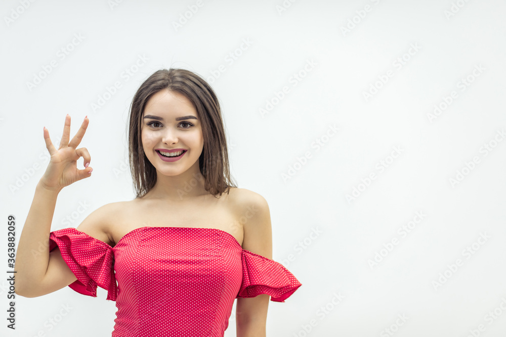 Close up image of lovely girl showing ok sign and smiling over white background. Close up image of lovely girl showing ok sign and smiling over white background.