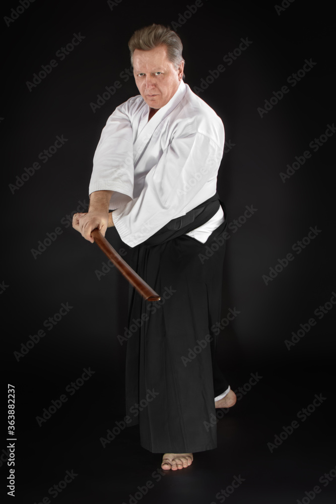 Portrait aikido master wearing traditional samurai hakama kimono. learning fight with bamboo boken Portrait aikido master wearing traditional samurai hakama kimono. learning fight with bamboo boken