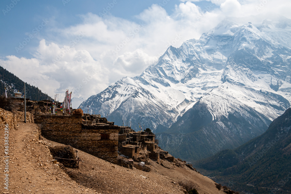 Ancient village of Ghyaru against the backdrop of mighty Annapurna II peak. Annapurna Circuit, Greater Himalayas, Nepal