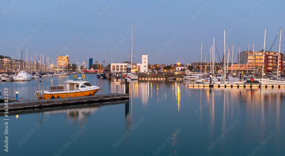Sailing boats in the marina of Zeebrugge during blue hour. Long exposure image