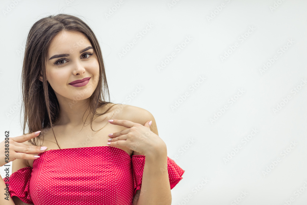 Portrait of a gorgeous elegant brunette in dress with shoulders naked over white background. Portrait of a gorgeous elegant brunette in dress with shoulders naked over white background.