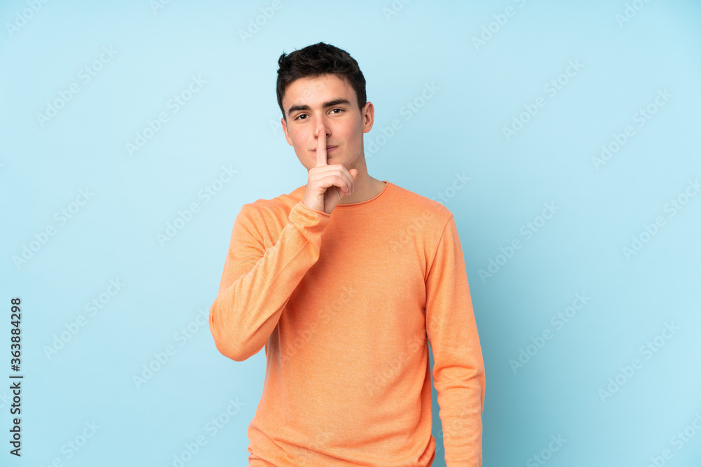 Teenager caucasian handsome man isolated on purple background doing silence gesture Teenager caucasian handsome man isolated on purple background doing silence gesture