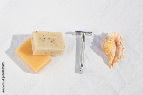 Steel shaving razor , pieces of soap , shell , on a white background