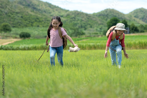 Asian girl and friend running and enjoy in the field meadows outdoors, adventure and tourism for destination leisure trips for education and relax in nature park.