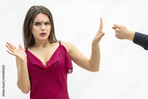 Negative human emotions and feelings. Lovely female frowning to the zilch sign her man shows her saying that she is going to get zero nothing. photo