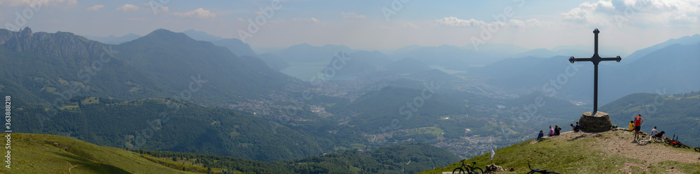 People at cross of Motto on Capriasca velley over Lugano in Switzerland