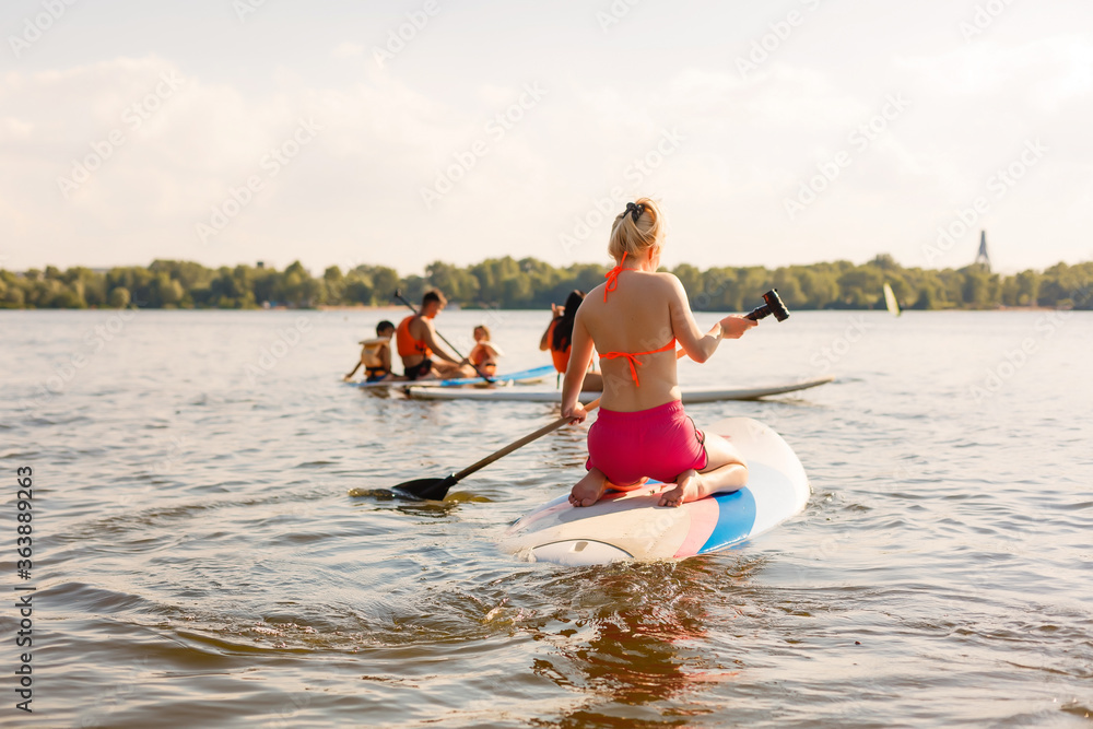 A beautiful woman practicing paddle on a beautiful sunny day A beautiful woman practicing paddle on a beautiful sunny day
