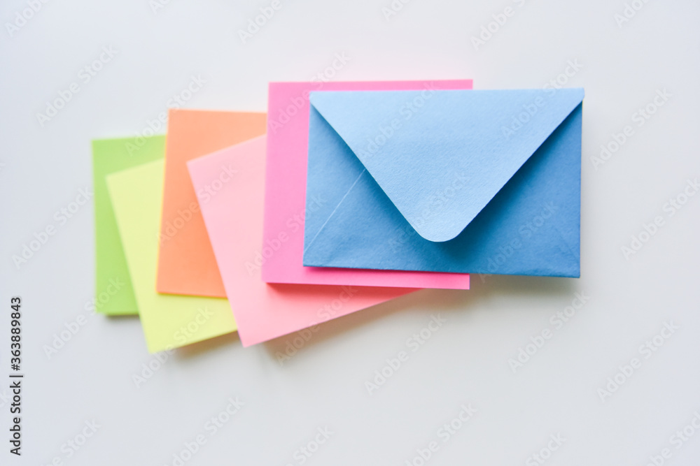 selective focus, blue envelope in the center with colored rectangles spreading under it selective focus, blue envelope in the center with colored rectangles spreading under it
