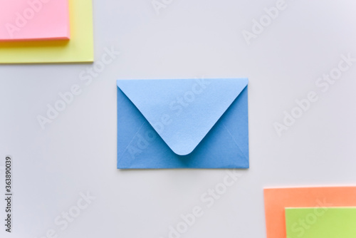 selective focus, blue envelope in the center with colored rectangles in corners