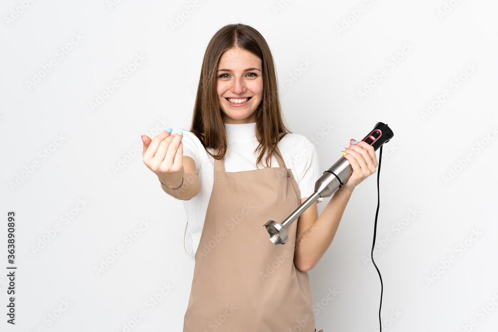 Young woman using hand blender isolated on white background inviting to come Young woman using hand blender isolated on white background inviting to come