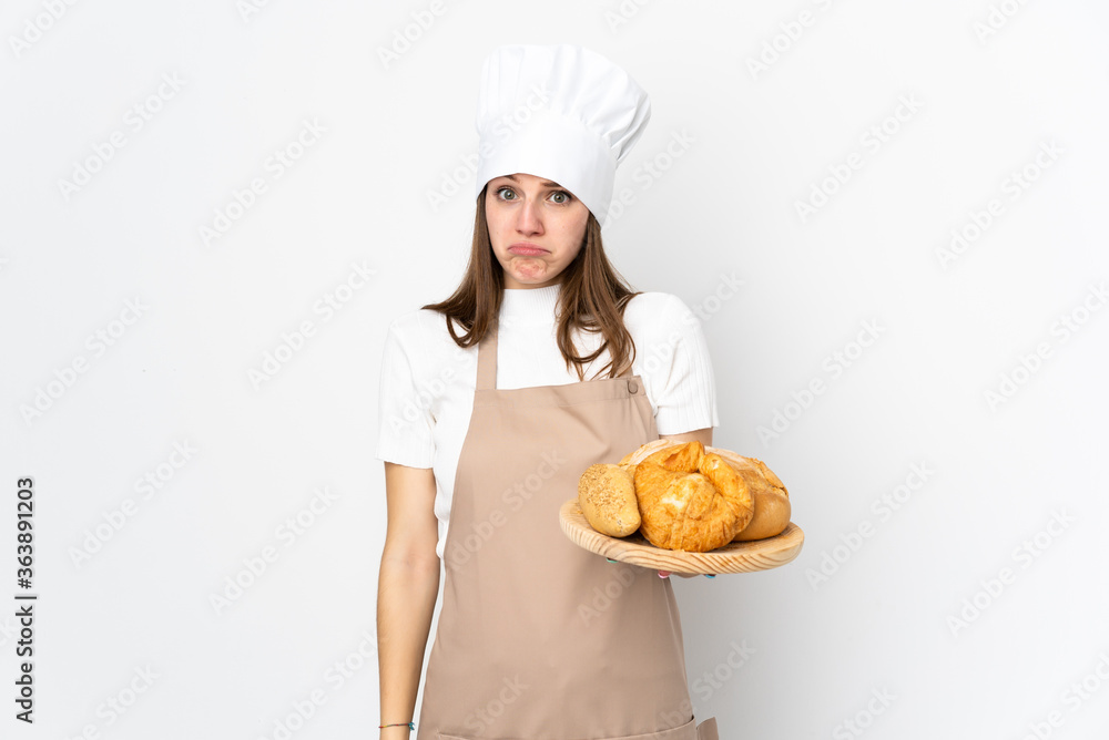 Young woman in chef uniform isolated on white background sad Young woman in chef uniform isolated on white background sad