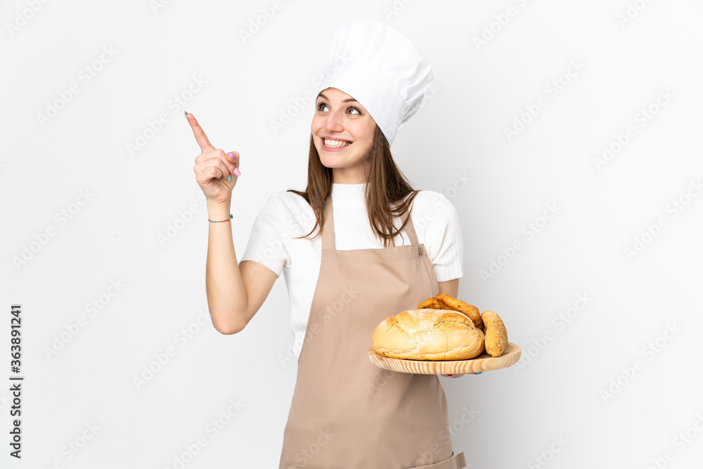 Young woman in chef uniform isolated on white background pointing with the index finger a great idea Young woman in chef uniform isolated on white background pointing with the index finger a great idea