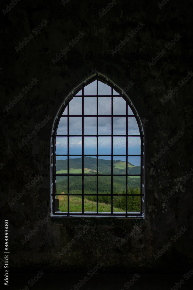 Old Castle Window view with the  landscape of São Miguel Island as background. Azores, Portugal.