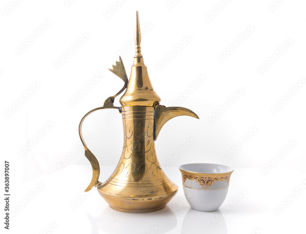 Traditional arabic coffee mug called Dallah and coffee cup on white background stock image