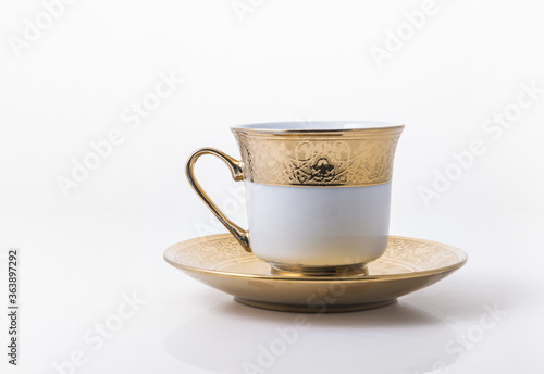 An arabic golden coffee cup with saucer.