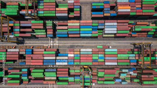Aerial view of area with stacked containers at the port, Top view stack of freight containers in rows at the shipyard, Global business cargo logistics shipping industry export import transportation.
