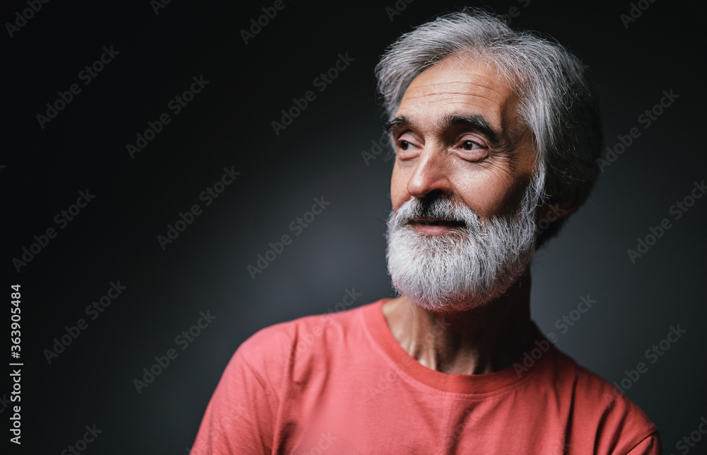 Obraz premium Studio portrait of handsome senior man with gray beard.