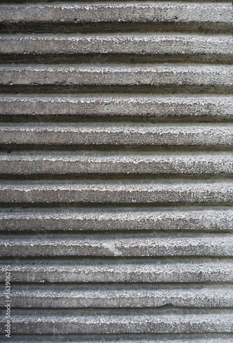 Grey concrete striped texture of wall. Close up detail of grey grunge cement wall.