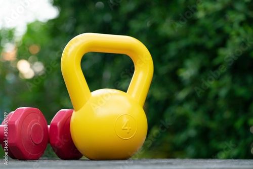 dumbbell and kettlebell on table background, fitness healthy and sport concept