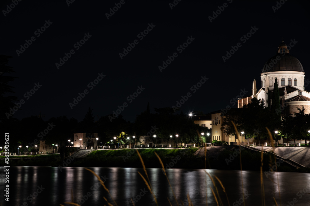Night photo along the river Adige with a view of the church San Giorgio city of Verona, Italy.